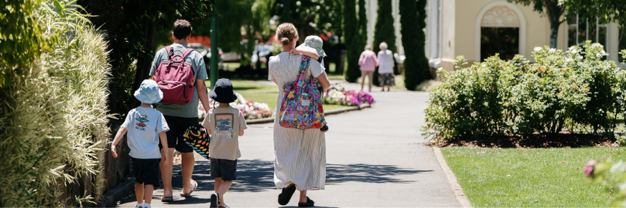 Family walking in city park