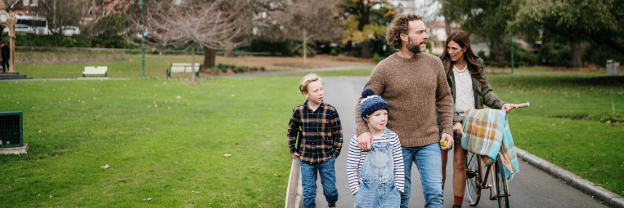 Family walking in city park