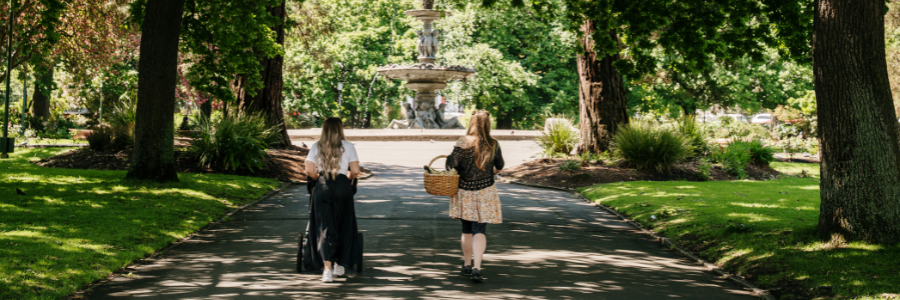 two girls walking through princes square